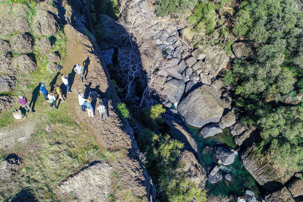Partners-at-Big-chico Kyle McHenry and project partners gather at the edge of Iron Canyon.