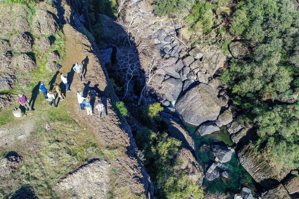 Kyle McHenry and project partners gather at the edge of Iron Canyon.