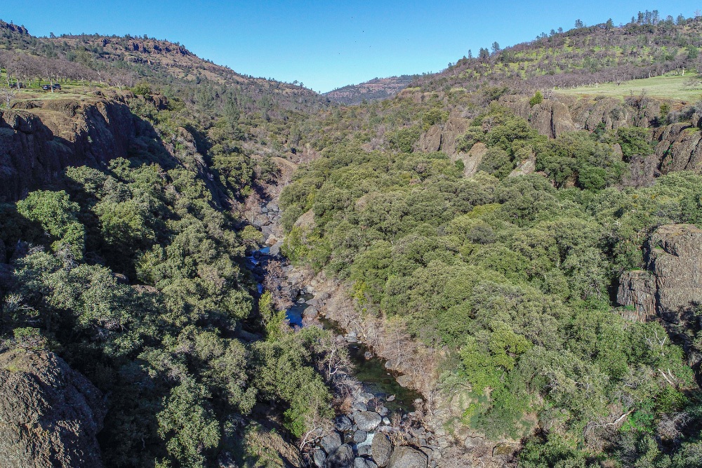 Big Chico Creek flows between giant cliff sides.
